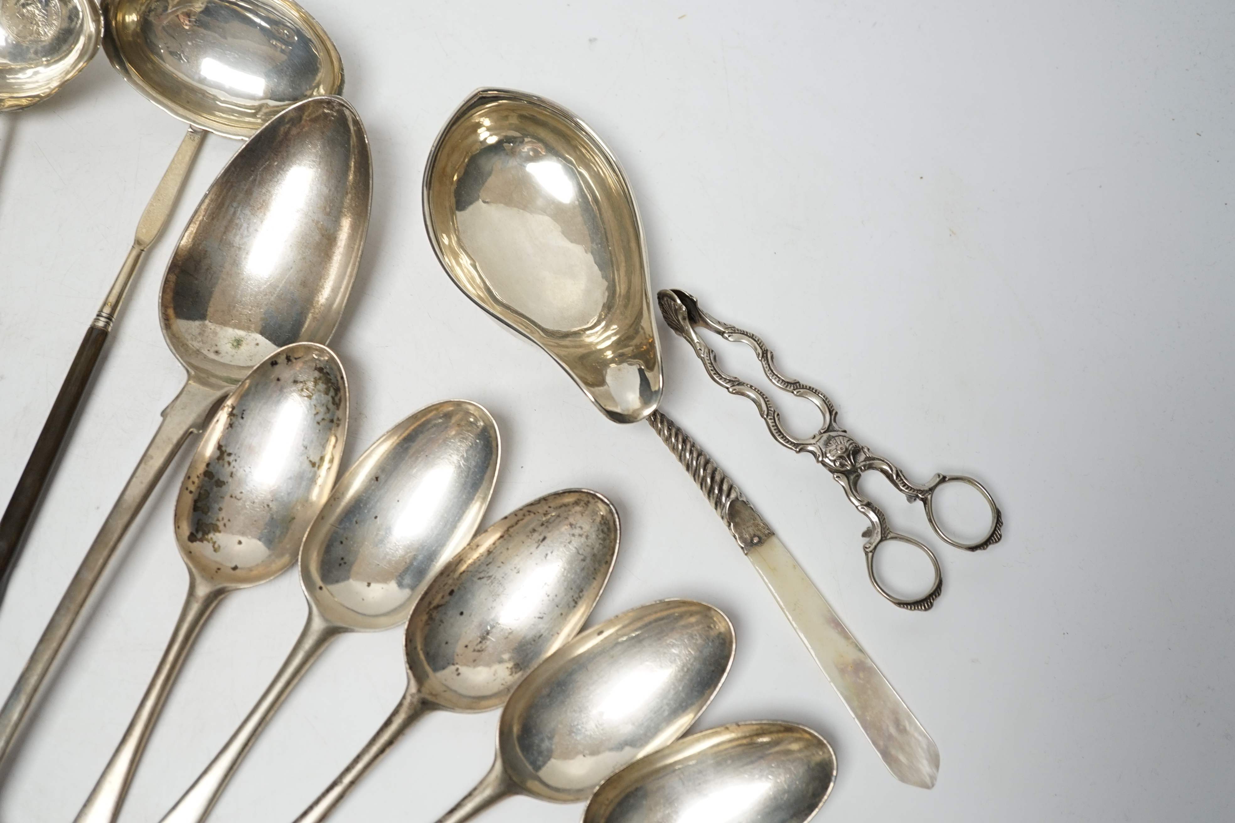 A late William IV silver fiddle pattern basting spoon, London, 1836, seven assorted 19th century silver base mark spoons, a Georgian Scottish dessert spoon, two toddy ladles, A George II brandy ladle, London, 1735, a Geo